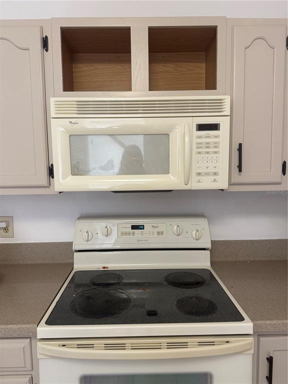 7027 Paul Revere Terrace New Port Richey, FL 34653 - Photo 3 of 20 a close view of stove and microwave