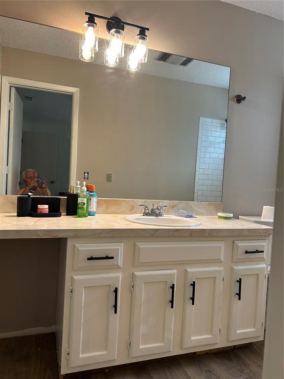 7027 Paul Revere Terrace New Port Richey, FL 34653 - Photo 4 of 20 a bathroom with a sink double vanity and a mirror