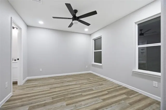 a view of a livingroom with a ceiling fan and wooden floor