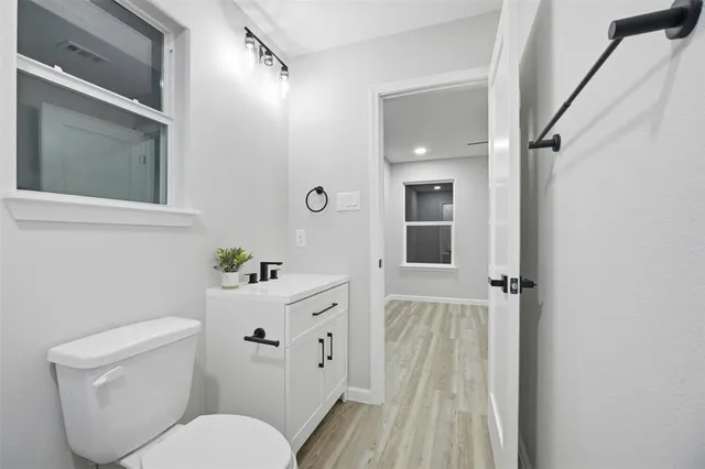 a white toilet sitting next to a bathroom sink