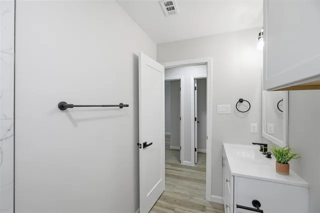 a bathroom with a sink a mirror and shower