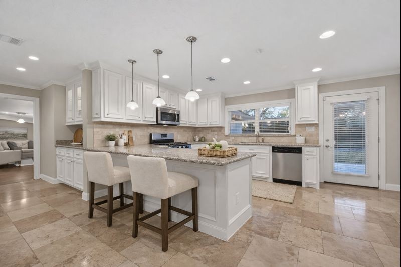 5323 Briarbend Drive Houston, TX 77096 - Photo 1 of 38 a kitchen with stainless steel appliances granite countertop a sink and a refrigerator
