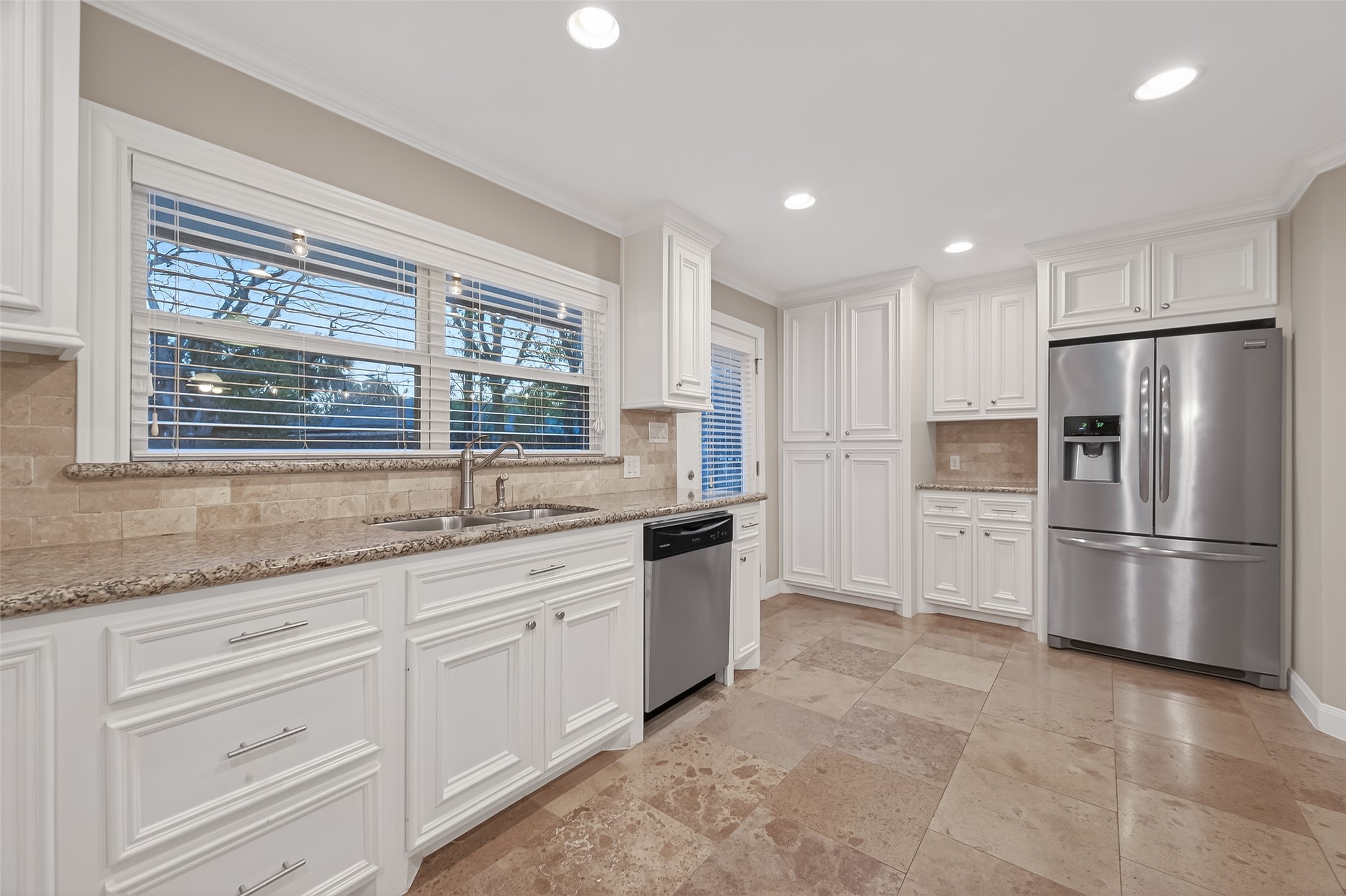5323 Briarbend Drive Houston, TX 77096 - Photo 11 of 38 a kitchen with granite countertop stainless steel appliances a refrigerator a sink a stove a microwave and cabinets