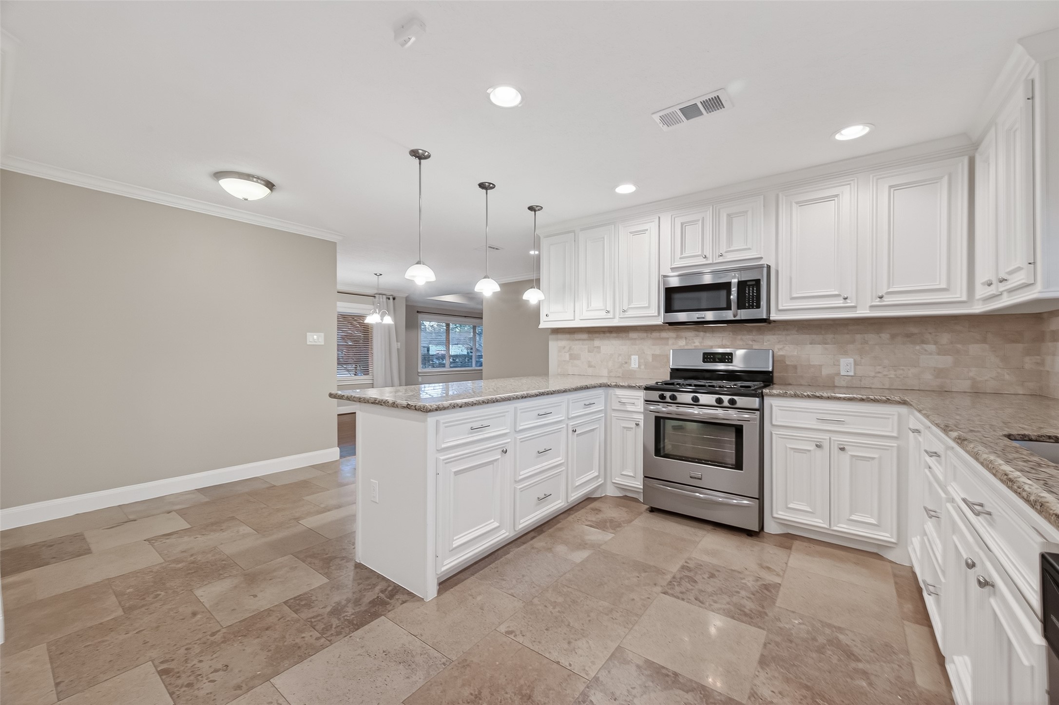 5323 Briarbend Drive Houston, TX 77096 - Photo 14 of 38 a kitchen with stainless steel appliances white cabinets a sink and a stove