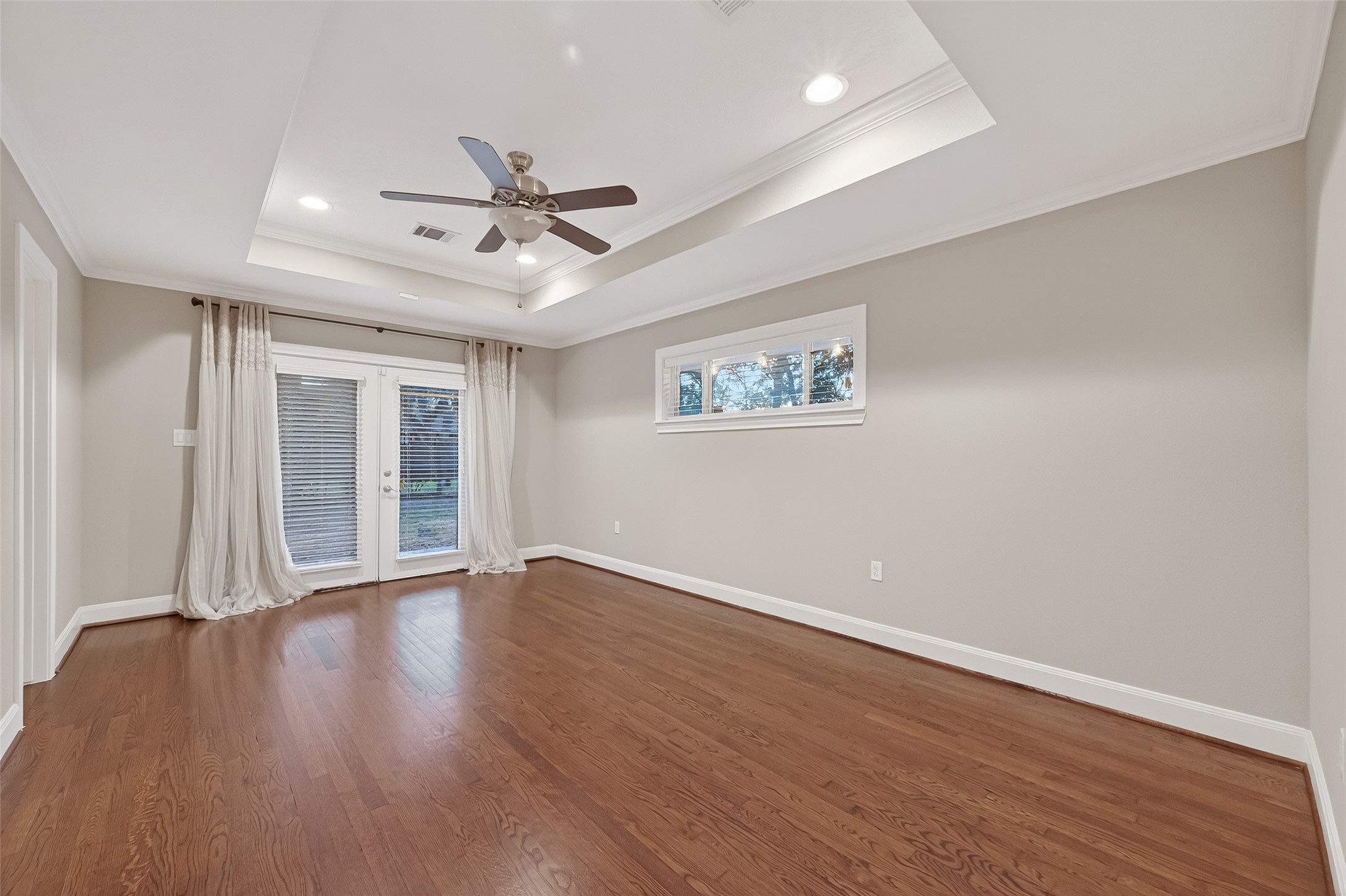 5323 Briarbend Drive Houston, TX 77096 - Photo 25 of 38 a view of an empty room with wooden floor and a ceiling fan