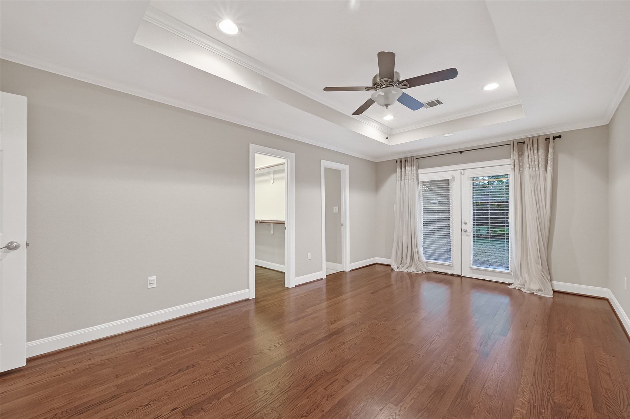 5323 Briarbend Drive Houston, TX 77096 - Photo 26 of 38 a view of an empty room with wooden floor and a ceiling fan