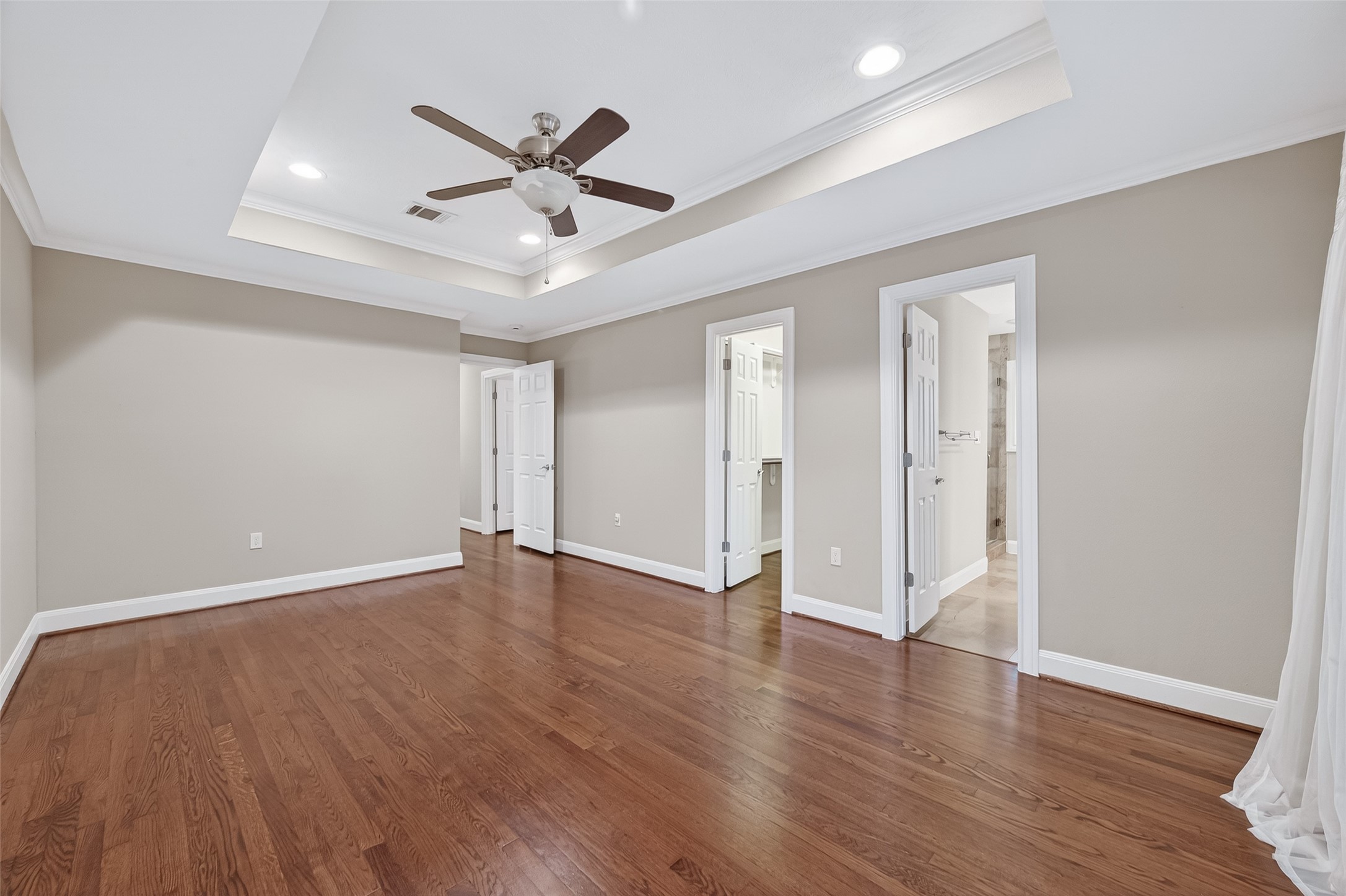 5323 Briarbend Drive Houston, TX 77096 - Photo 27 of 38 a view of an empty room with wooden floor and a ceiling fan