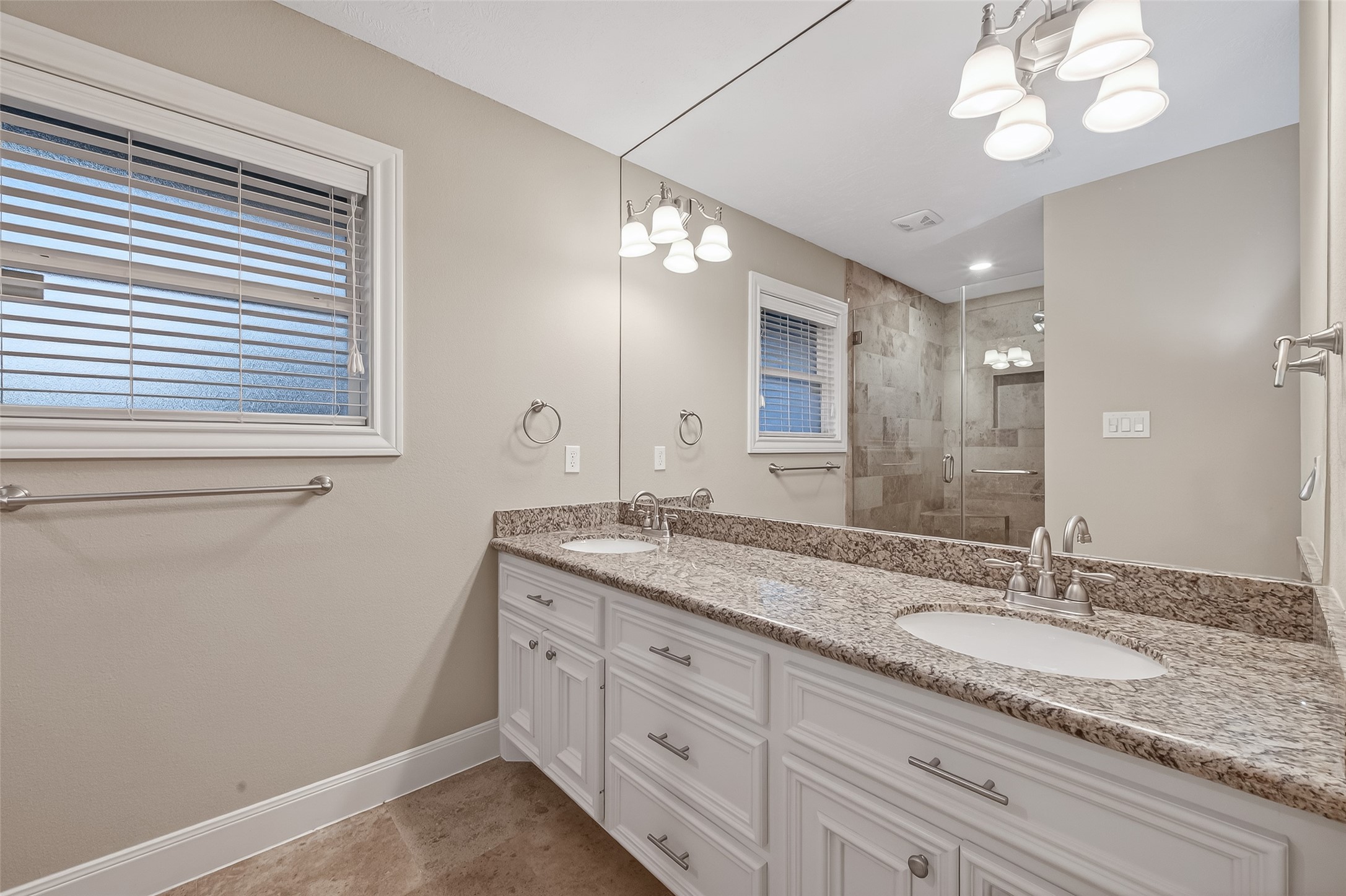 5323 Briarbend Drive Houston, TX 77096 - Photo 29 of 38 a bathroom with a granite countertop double vanity and a mirror