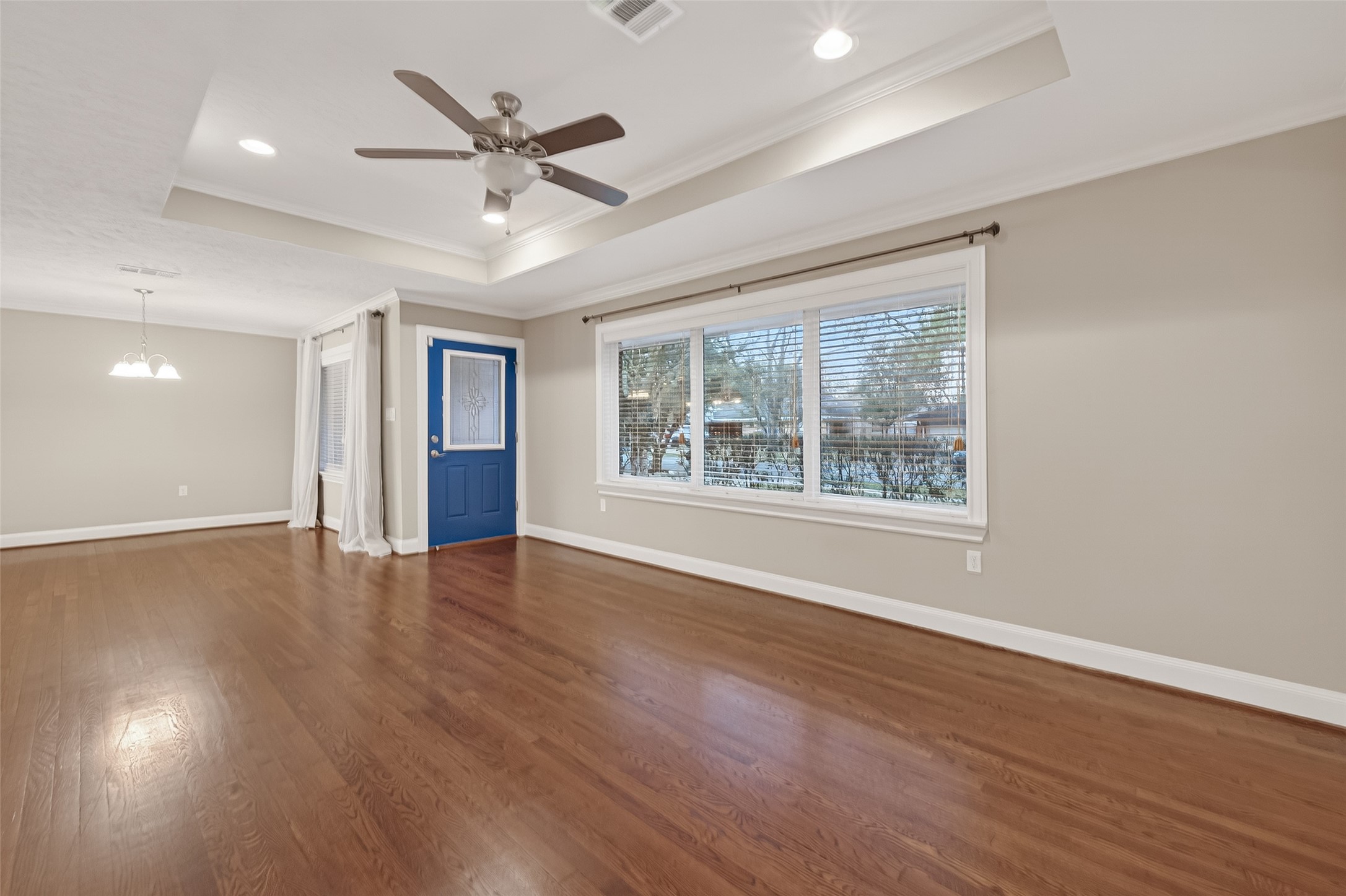 5323 Briarbend Drive Houston, TX 77096 - Photo 4 of 38 a view of an empty room with wooden floor and a window