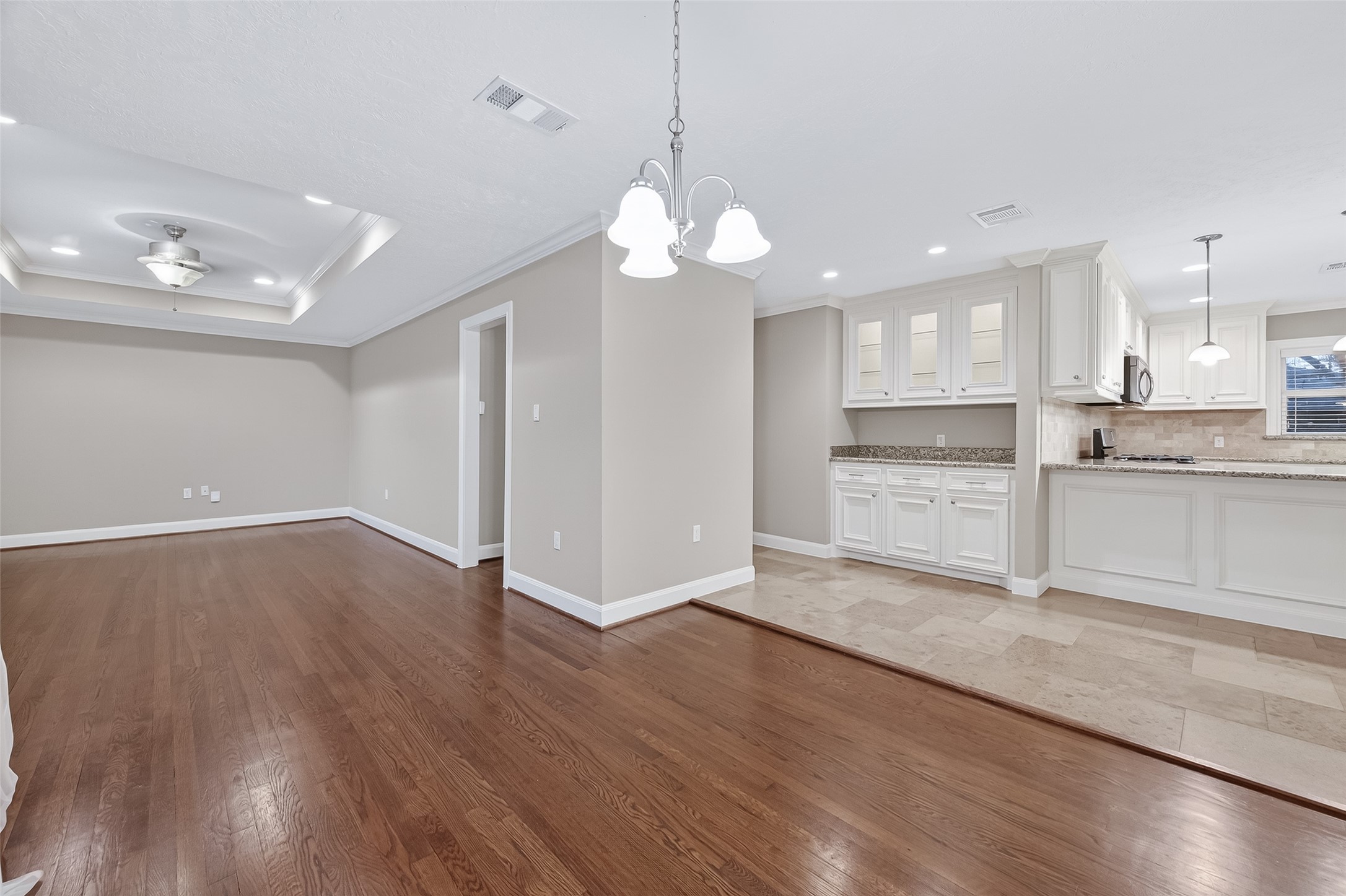 5323 Briarbend Drive Houston, TX 77096 - Photo 6 of 38 a view of a kitchen with a stove cabinets a refrigerator and wooden floor