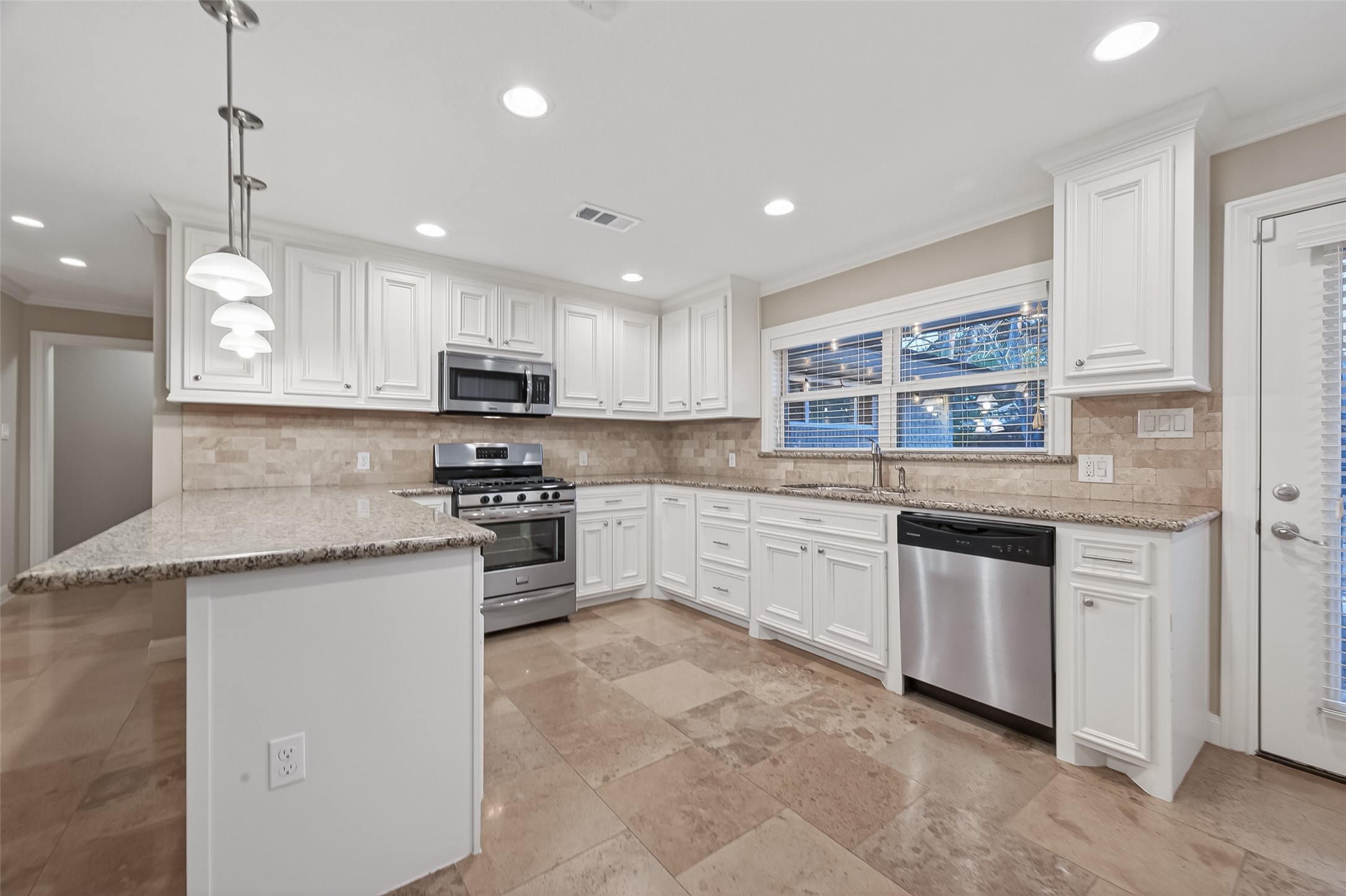 5323 Briarbend Drive Houston, TX 77096 - Photo 9 of 38 a kitchen with stainless steel appliances granite countertop a stove top oven a sink a refrigerator and a granite island