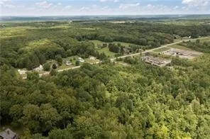 a view of a field with an ocean