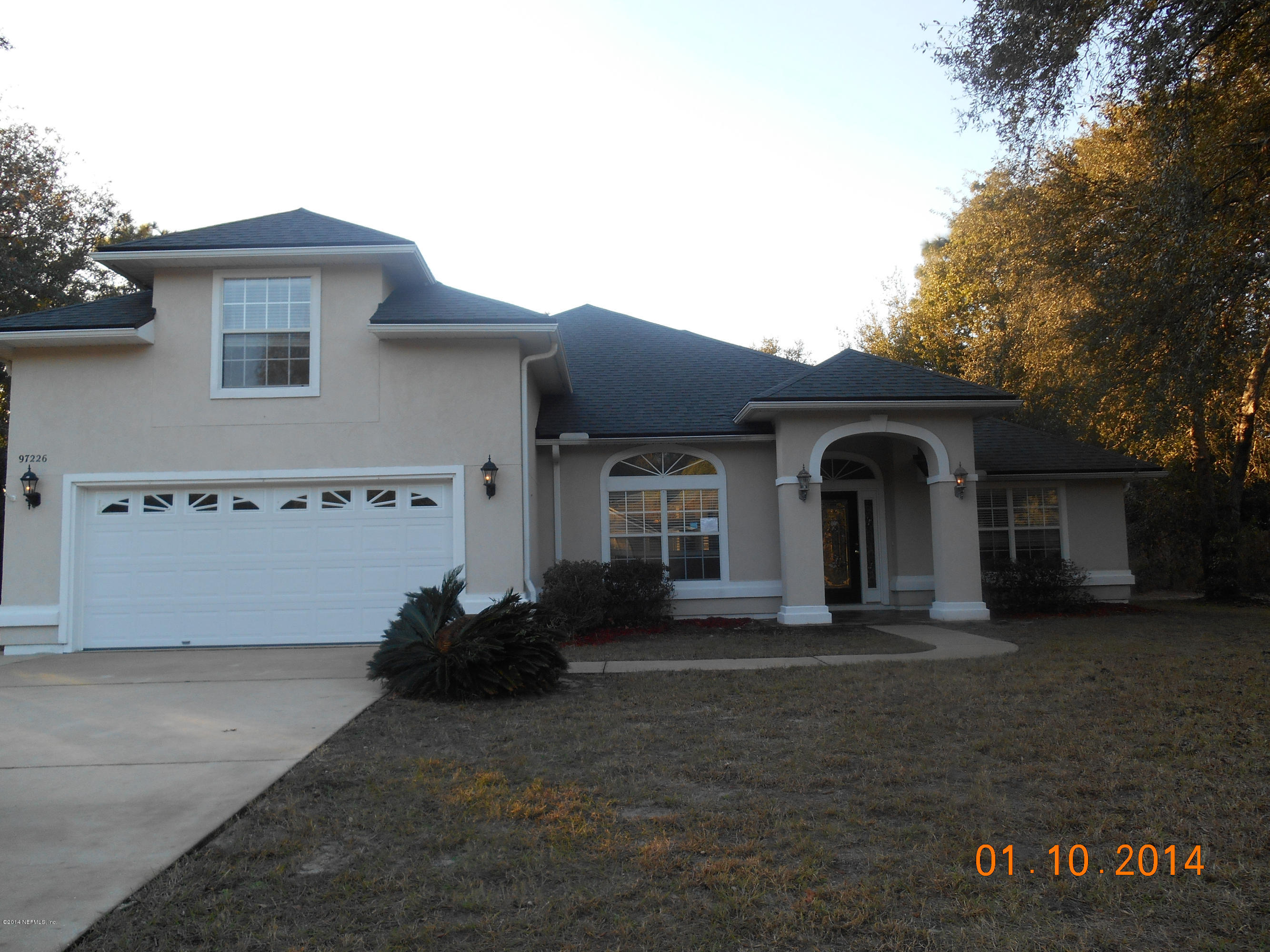 97226 Castle Ridge Drive Yulee, FL 32097 - Photo 1 of 15 a front view of a house with a yard