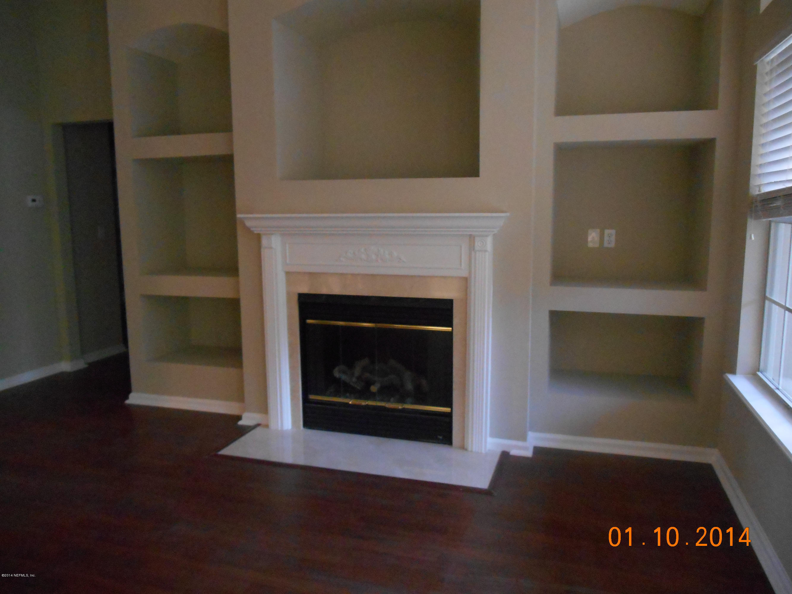 97226 Castle Ridge Drive Yulee, FL 32097 - Photo 11 of 15 a living room with a fireplace