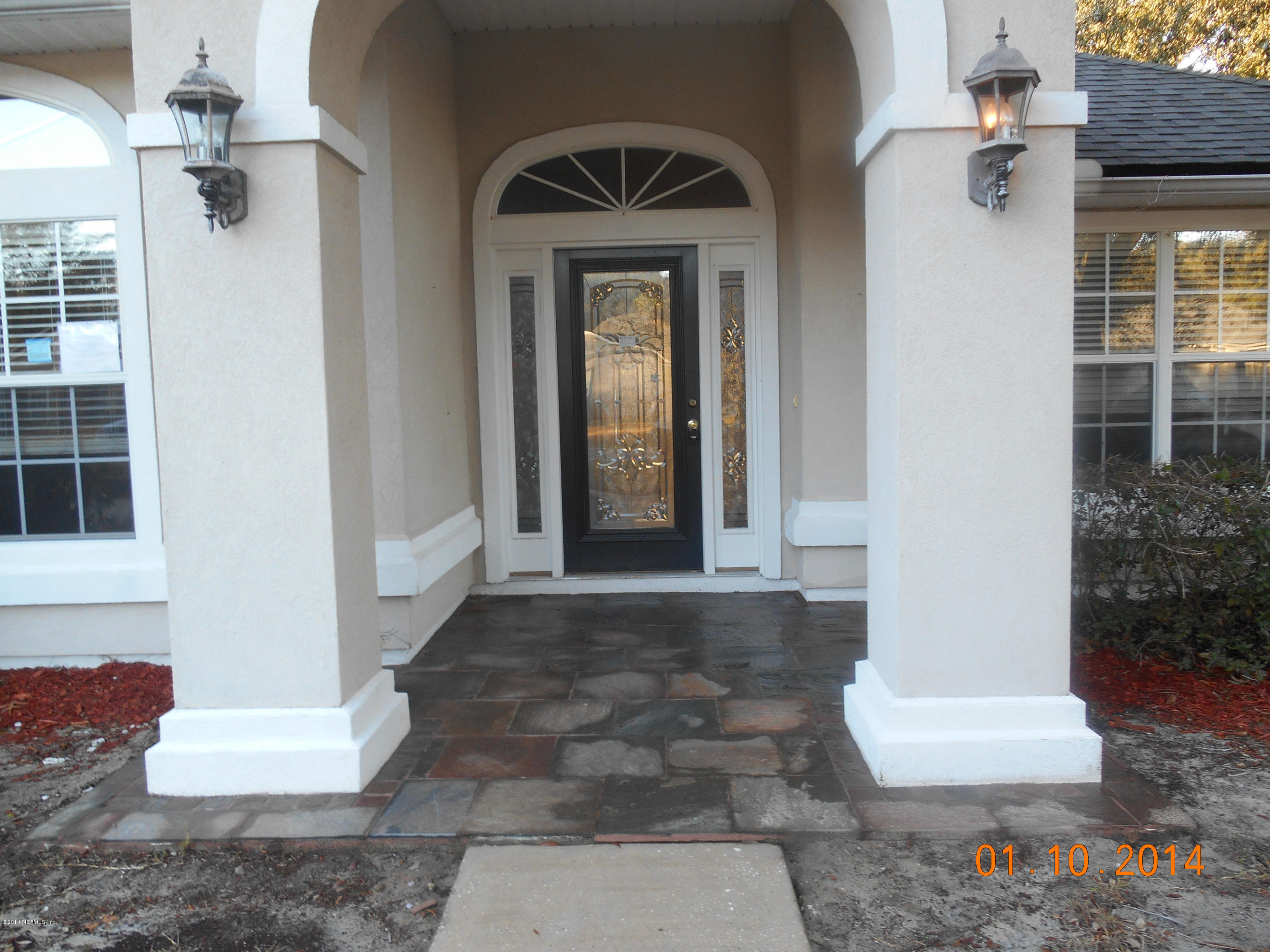 97226 Castle Ridge Drive Yulee, FL 32097 - Photo 2 of 15 a front view of a house with a yard