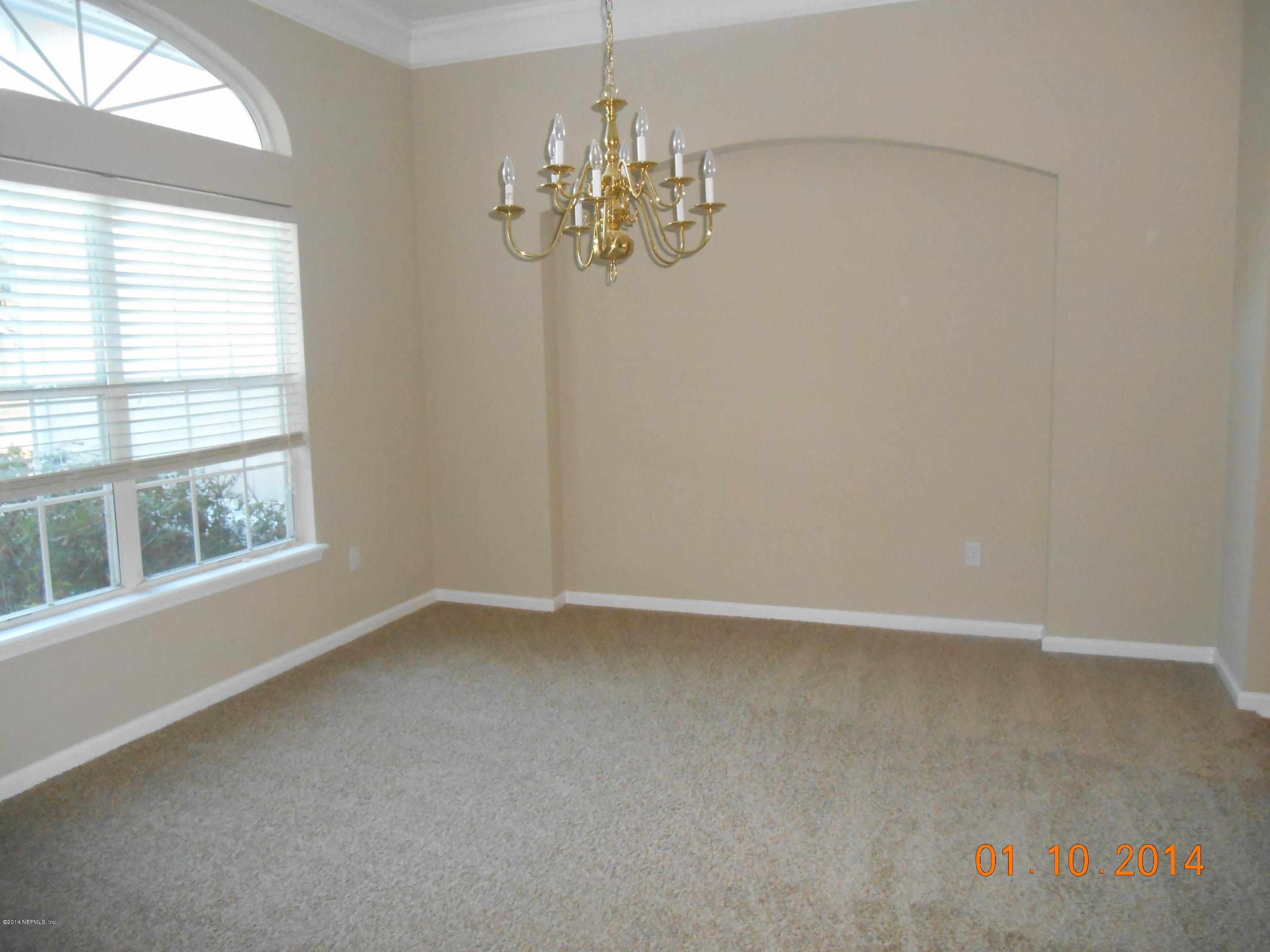 97226 Castle Ridge Drive Yulee, FL 32097 - Photo 4 of 15 an empty room with chandelier and windows
