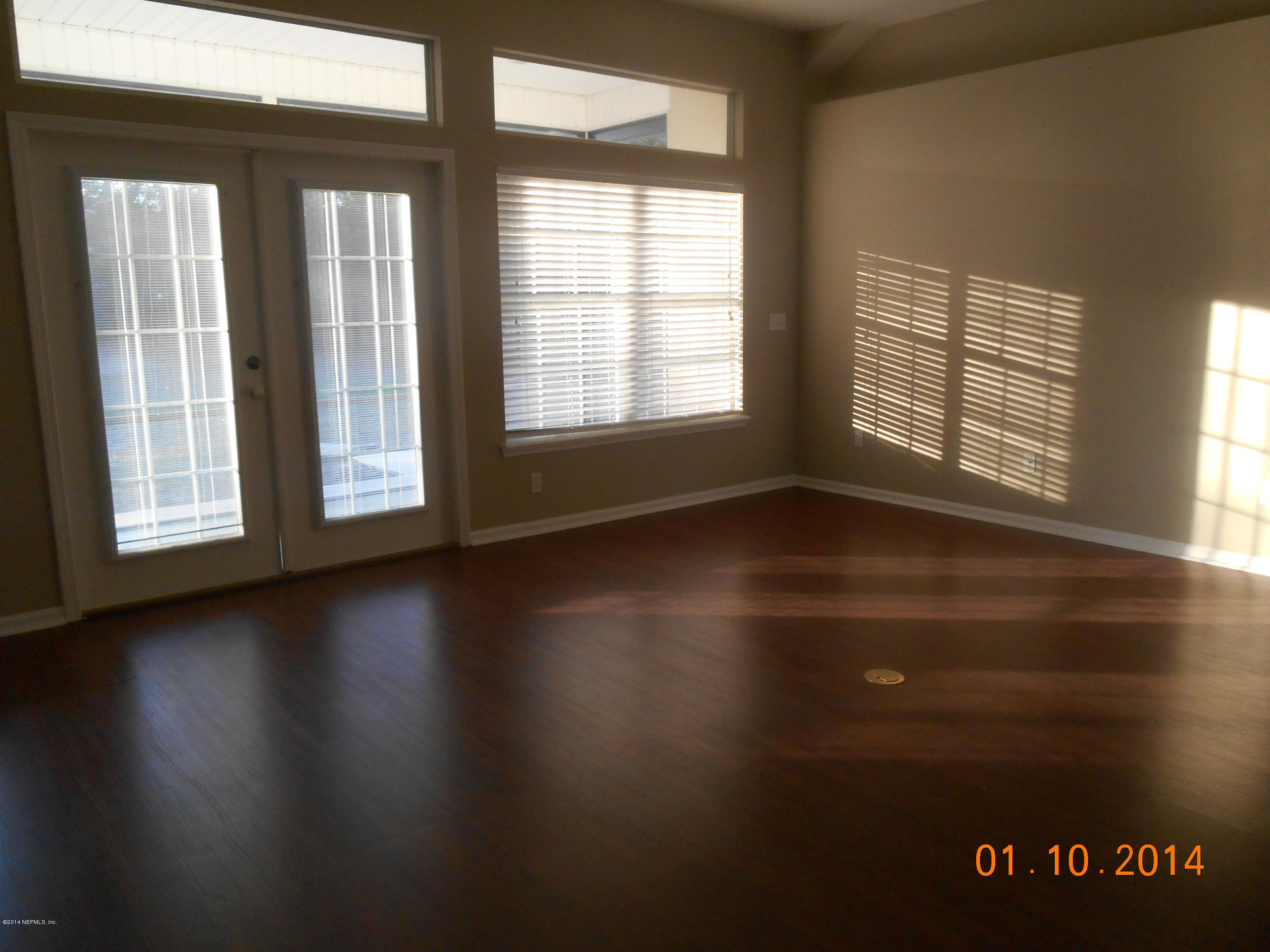 97226 Castle Ridge Drive Yulee, FL 32097 - Photo 9 of 15 a view of an empty room with wooden floor and a window