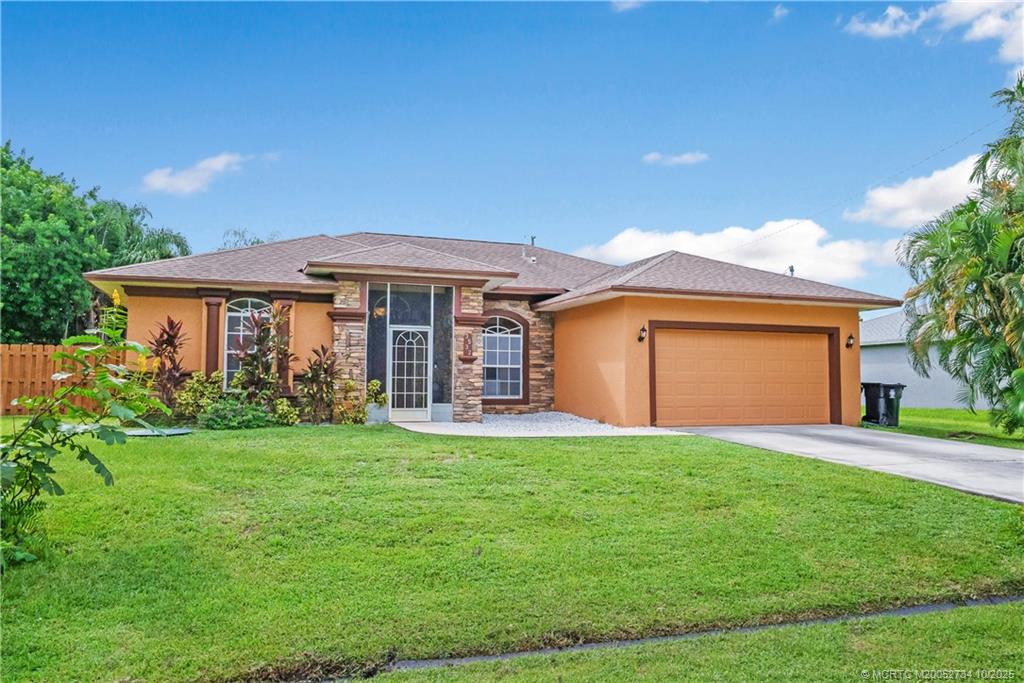 a front view of a house with a yard and garage