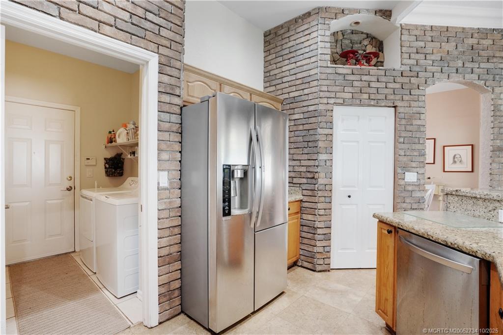 3532 Southwest Margela Street Port St. Lucie, FL 34953 - Photo 11 of 29 a kitchen with a refrigerator and a sink