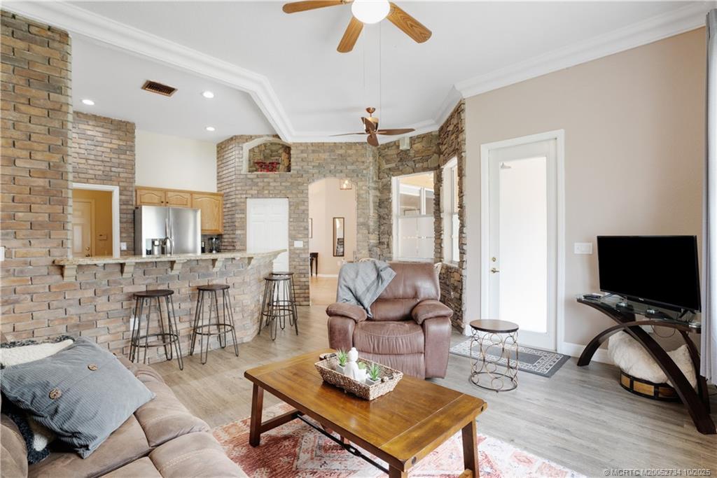 3532 Southwest Margela Street Port St. Lucie, FL 34953 - Photo 12 of 29 a living room with furniture a flat screen tv and a large window