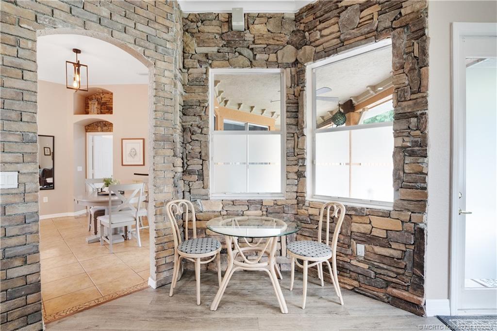 3532 Southwest Margela Street Port St. Lucie, FL 34953 - Photo 13 of 29 a dining room with furniture a chandelier and wooden floor