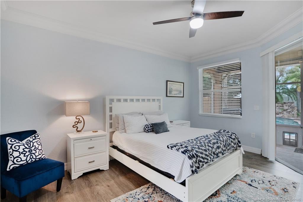 3532 Southwest Margela Street Port St. Lucie, FL 34953 - Photo 14 of 29 a bedroom with a bed and wooden floor