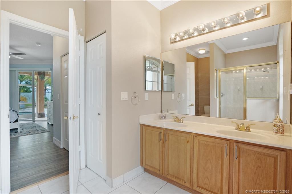 3532 Southwest Margela Street Port St. Lucie, FL 34953 - Photo 17 of 29 a bathroom with a double vanity sink a mirror and a shower