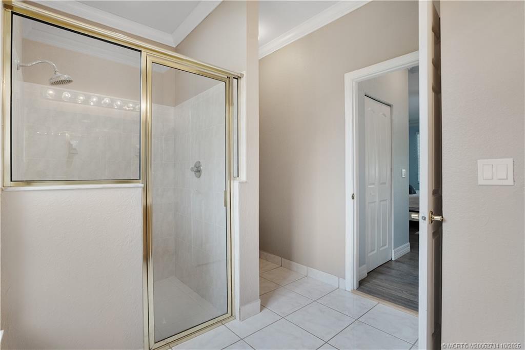 3532 Southwest Margela Street Port St. Lucie, FL 34953 - Photo 18 of 29 a bathroom with a glass shower door and a glass door