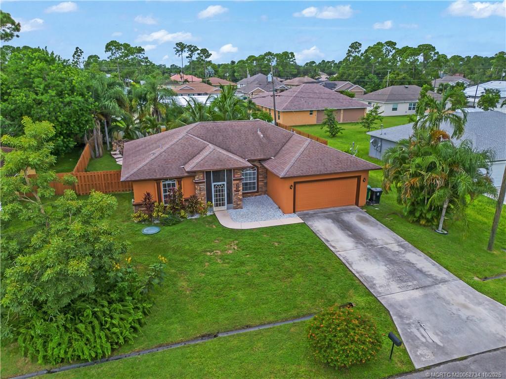 3532 Southwest Margela Street Port St. Lucie, FL 34953 - Photo 2 of 29 an aerial view of a house with garden space and a street view