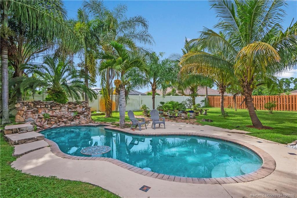 3532 Southwest Margela Street Port St. Lucie, FL 34953 - Photo 25 of 29 a view of a backyard with palm trees