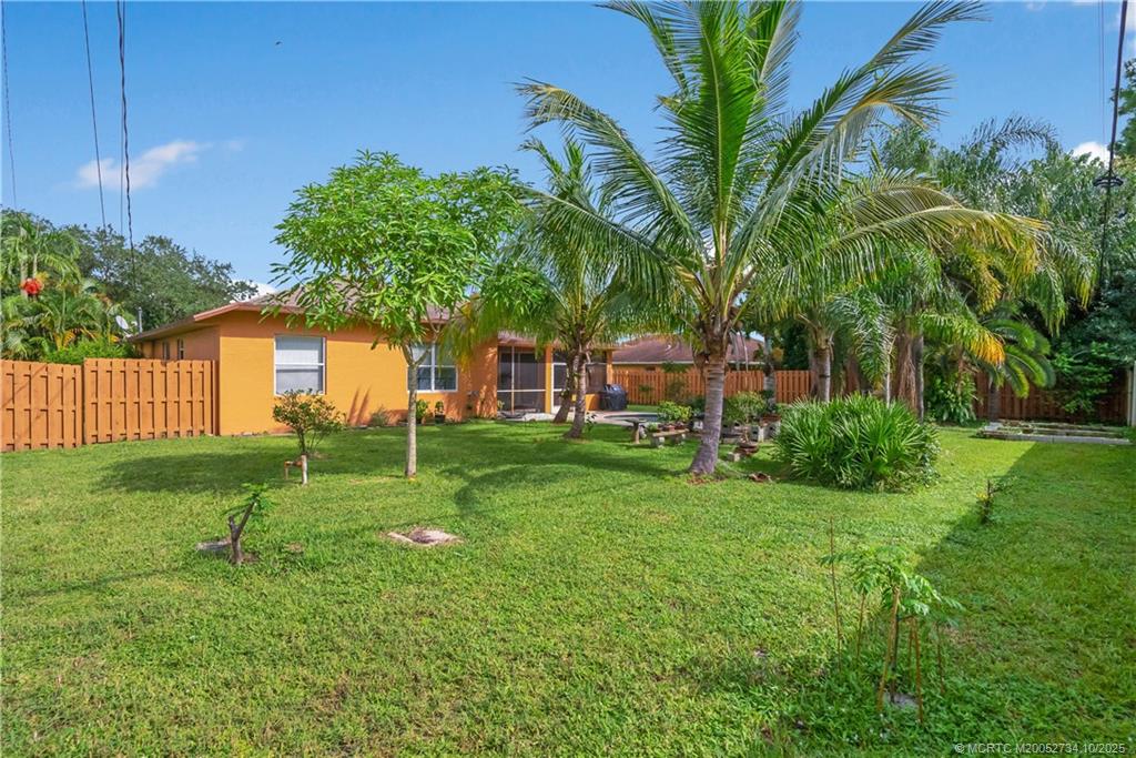 3532 Southwest Margela Street Port St. Lucie, FL 34953 - Photo 27 of 29 a view of a house with a backyard