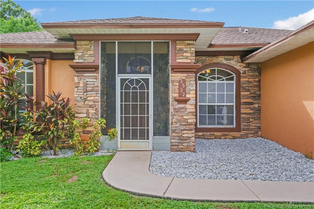 3532 Southwest Margela Street Port St. Lucie, FL 34953 - Photo 4 of 29 front view of a house with a yard
