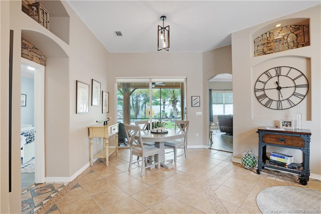 3532 Southwest Margela Street Port St. Lucie, FL 34953 - Photo 5 of 29 a living room with furniture a window and a chandelier