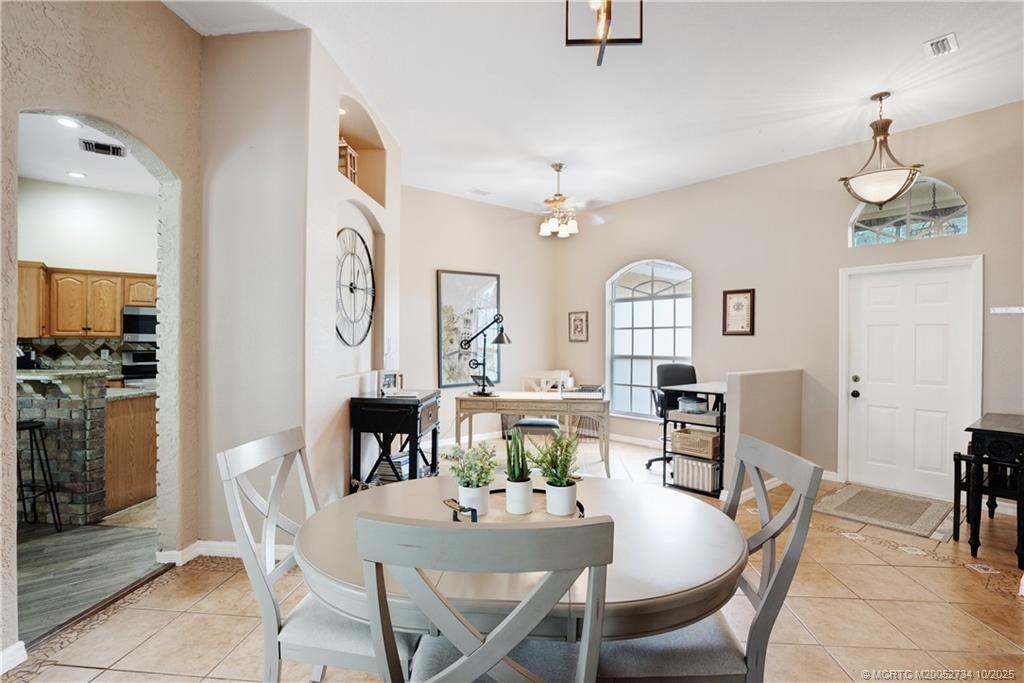 3532 Southwest Margela Street Port St. Lucie, FL 34953 - Photo 8 of 29 a view of a dining room with furniture window and wooden floor