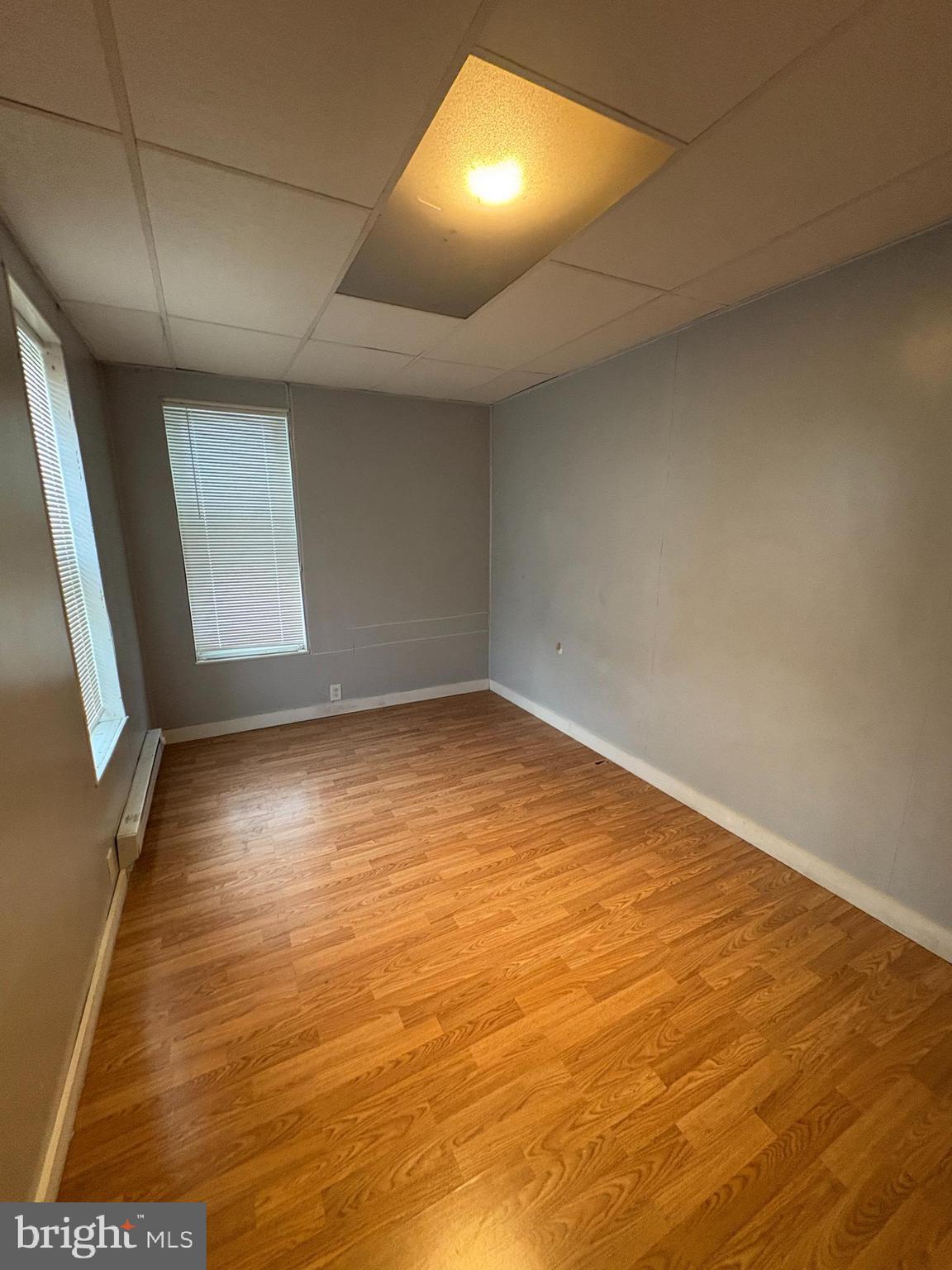1512 Haak Street Reading, PA 19602 - Photo 3 of 10 an empty room with wooden floor and windows