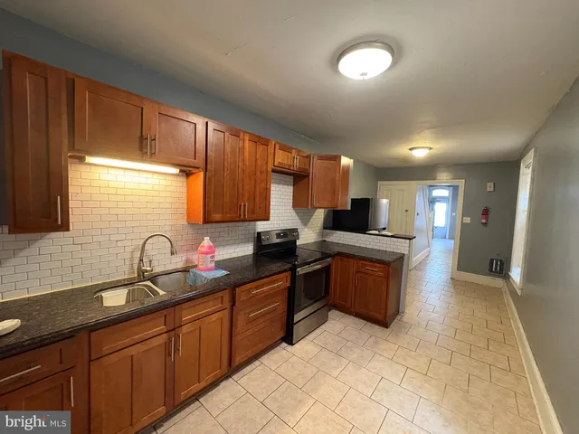 a large kitchen with lots of counter space and a sink