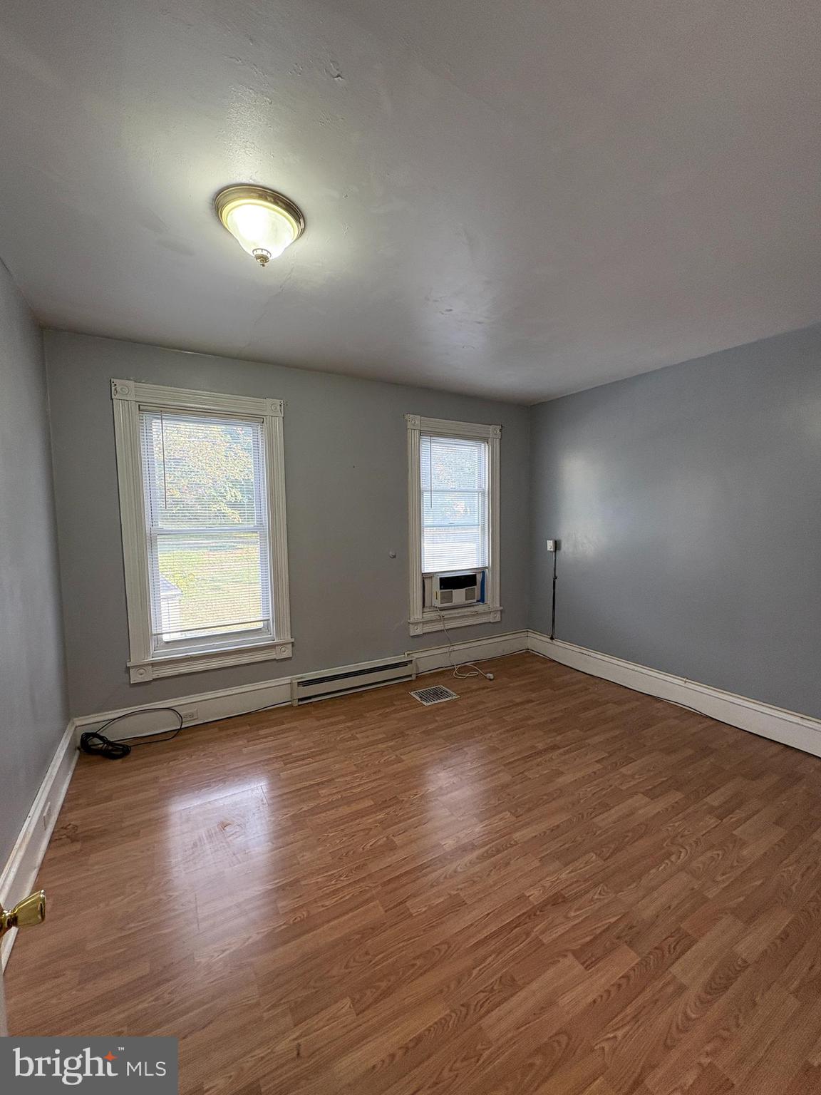 1512 Haak Street Reading, PA 19602 - Photo 9 of 10 an empty room with wooden floor and windows