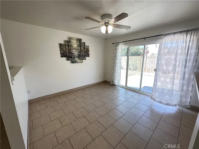 an empty room with fireplace and windows
