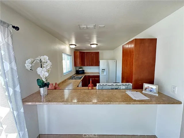a kitchen with a stove a refrigerator and a sink