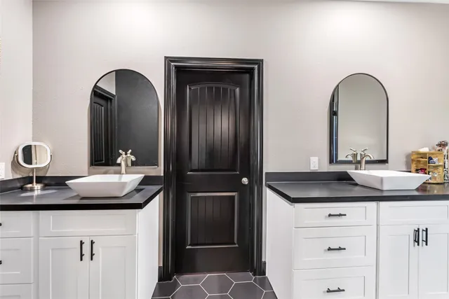 a bathroom with a double vanity sink and a mirror