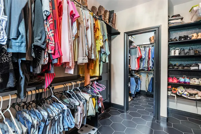 a bedroom with a bed and a flat tv screen on dresser