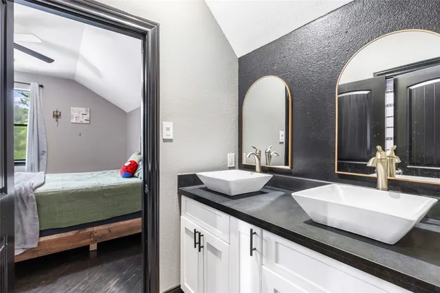 a bedroom with a bed and large windows