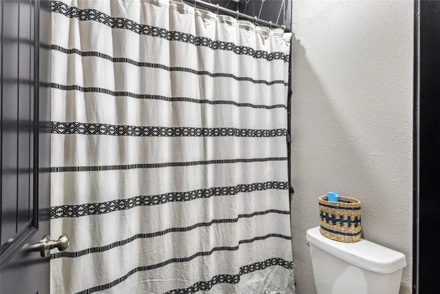 a bedroom with bed and wooden floor