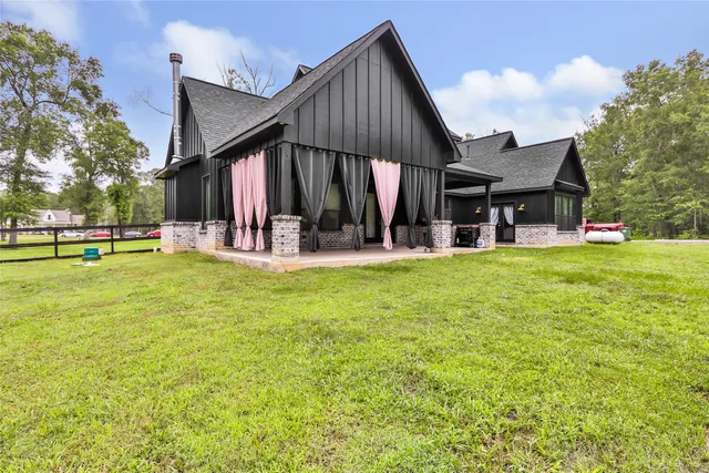 a view of a livingroom with furniture and floor to ceiling window