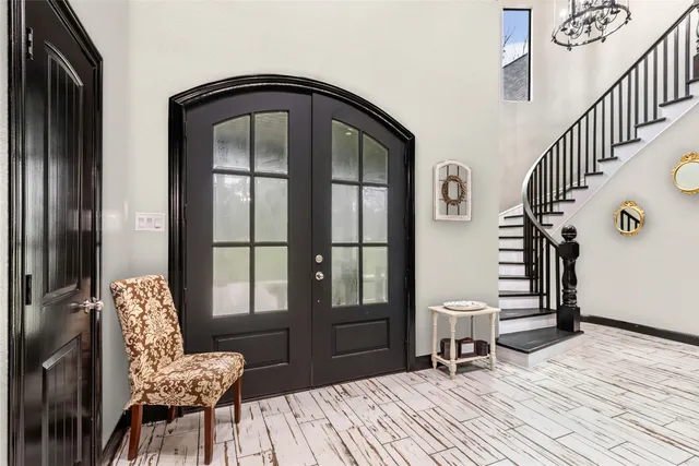 a dining hall with stainless steel appliances granite countertop a stove and a wooden floors