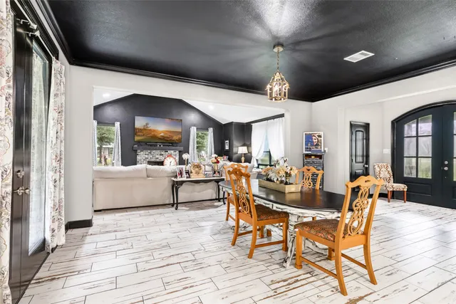a kitchen with a table chairs sink and cabinets