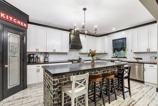 a living room with furniture a flat screen tv and a large window