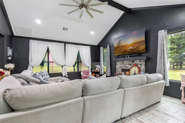 a living room with furniture flat screen tv and a fireplace