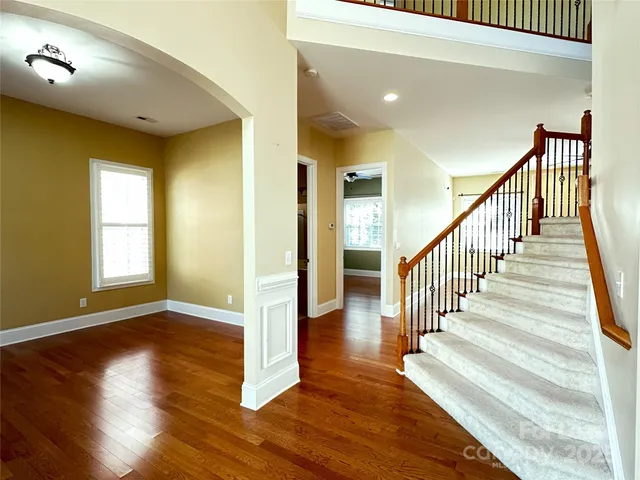 a view of entryway and hall with wooden floor