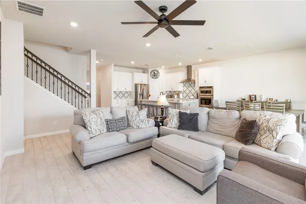 a spacious bedroom with a bed and a chair